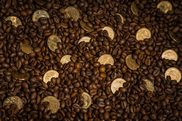 gold coins among coffee beans