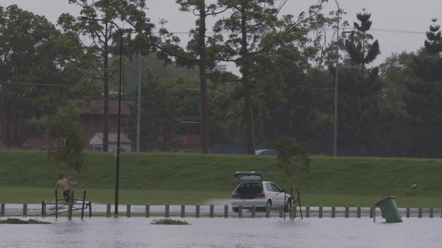 Flood conditions provide endless fun for these boys skim boarding on flood lands