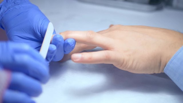 close-up. manicure. deburring scissors. manicure process for men.