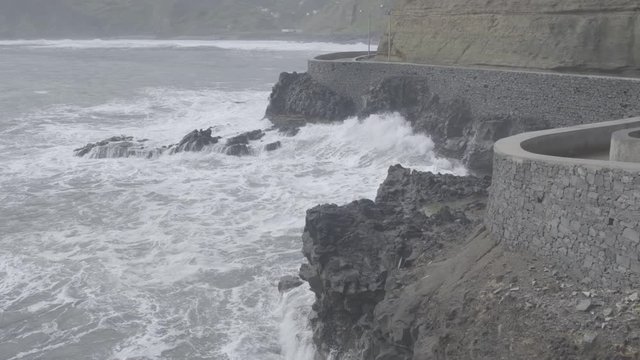 Slow-mo of water hitting a rock wall 