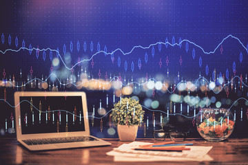 Forex graph hologram on table with computer background. Double exposure. Concept of financial markets.