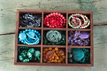 Beads from natural stones for making jewelry and souvenirs in the box.