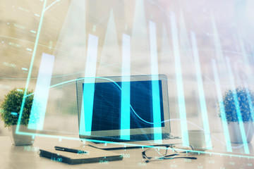 Forex graph hologram on table with computer background. Multi exposure. Concept of financial...