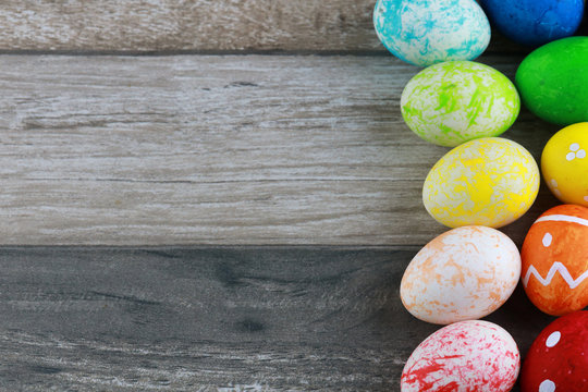 Group colorful and decorated easter eggs on vintage wooden table background. Advertising image Easter festival concept with free space.
