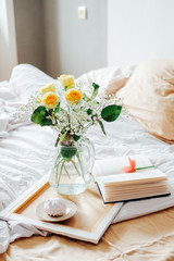 Lazy morning in bed. Flowers and tea for two.