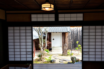 View of the garden from the inside of an old Japanese house with shoji paper sliding doors