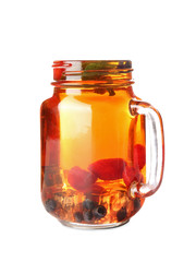 Mason jar of cold tea on white background
