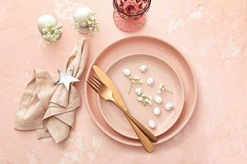 Beautiful Easter table setting on color background