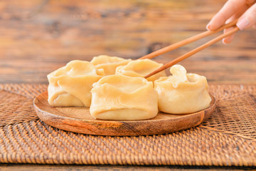 Eating of tasty oriental dumplings, closeup