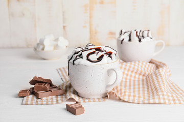 Cup of hot chocolate on white wooden table