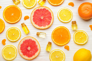 Composition with citrus essential oils on white wooden background