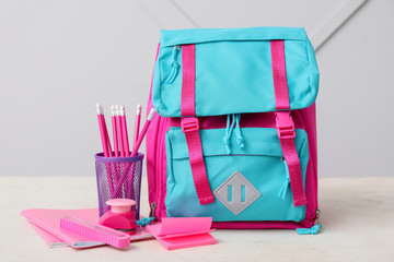 Bright pink and blue school backpack with pencils and stationery for education and learning © Pixel-Shot