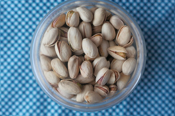 top view of pistachios in a jar on table 