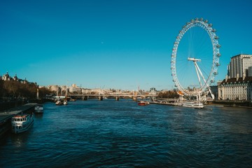 Wide angle of the London Eye next to the river Thames in the UK - obrazy, fototapety, plakaty