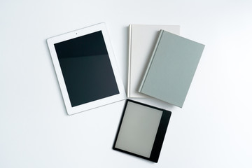 ebook and books on white desktop.Books and tablet on white background.