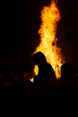 group of people enjoying a bonfire in a festive atmosphere. unrecognizable people. Party and vacation concept. Christianized Celtic party.