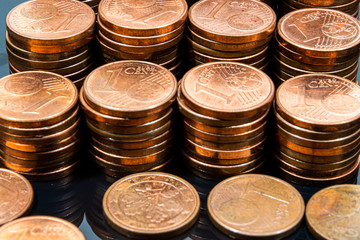 One euro cents coins on dark background. European money.
