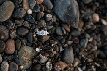 Engagement wedding ring on rocky beach