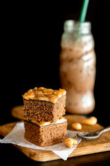 sweet brownie garnished with cashew nut in a dark background.