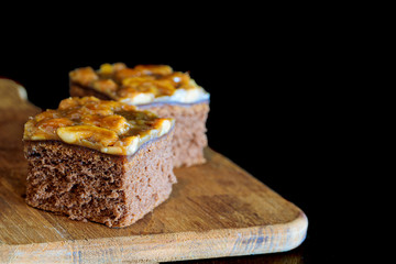 sweet brownie garnished with cashew nut in a dark background.