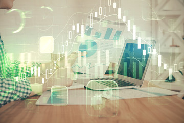 Double exposure of financial graph with man works in office on background. Concept of analysis.