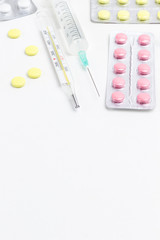 Pill to treat colds and thermometer, syringe