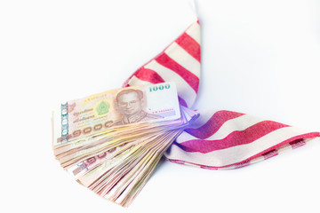 Thai money banknotes 1000 baht on red and white ribbon. White background, business investment concept .Selective focus.