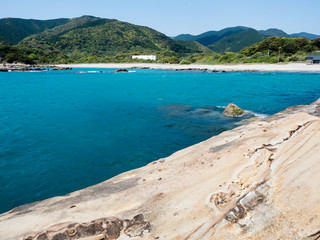 Fototapeta premium Sandstone rock formations and clear blue waters at Tatsukushi coast - a natural scenic landmark near Tosashimizu, Kochi prefecture, Japan