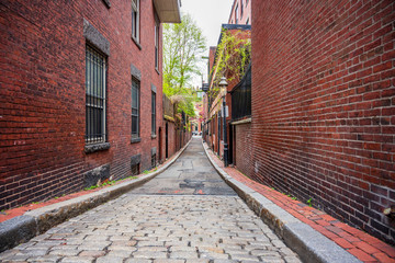 Narrow cobblestone street with brick houses of old Boston