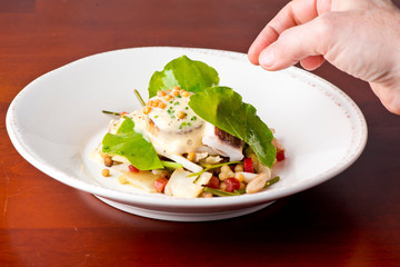 Scallops. Pan seared jumbo sea scallops, sauteed in garlic herb butter and plated with fresh vegetables and a reduction sauce. Classic French Bistro Dish.  Plated by a chef