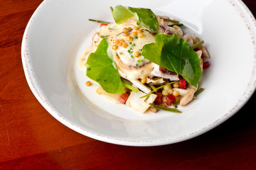 Scallops. Pan seared jumbo sea scallops, sauteed in garlic herb butter and plated with fresh vegetables and a reduction sauce. Classic French Bistro Dish.  Plated by a chef