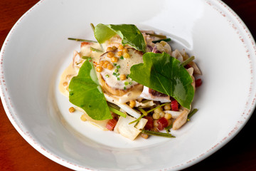 Scallops. Pan seared jumbo sea scallops, sauteed in garlic herb butter and plated with fresh vegetables and a reduction sauce. Classic French Bistro Dish.  Plated by a chef.