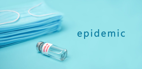 Epidemic background. COVID-19 Coronavirus background. Vaccine from COVID-19. Blue medical disposable face mask with covid-19 print. Dangerous virus, bacteria. Epidemic over the world.