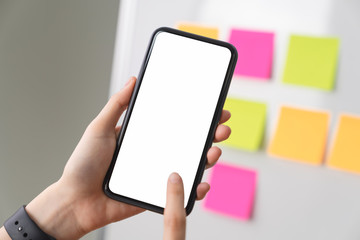 Hand holding blank screen of smartphone on the desk office and for graphic display montage.