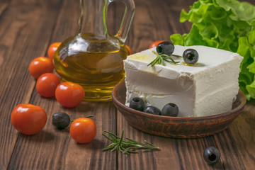Feta cheese and cherry tomatoes scattered on the table.