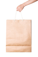 Woman hand hold a craft shopping bag isolated on white.