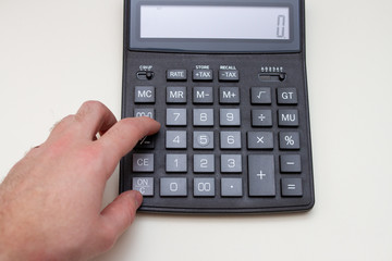 Businessman using a calculator to calculate the numbers. Business and finance accounting concept.