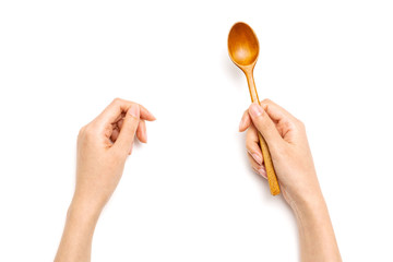 Woman hand hold a wood spoon isolated on white.