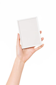 Woman hand hold a photo, picture frame isolated on white.