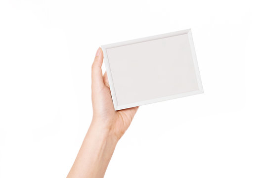 Woman hand hold a photo, picture frame isolated on white.