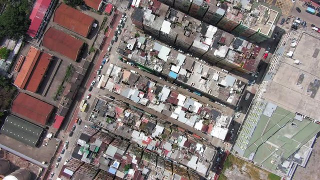 Hong Kong Kowloon Walled City, a densely populated slum, Top down spin aerial view.