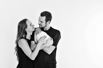 the concept of a healthy lifestyle, the protection of children, shopping - baby in the arms of the mother and father. Woman and man holding a child. Isolated on white background. Copy space
