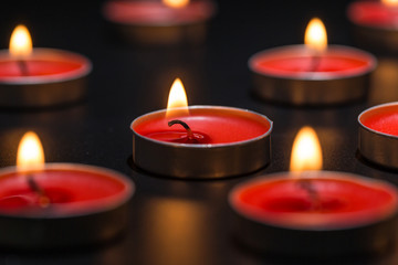 Candles burning on a black background