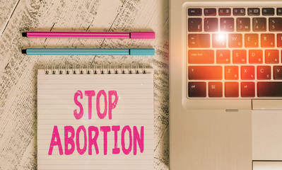 Writing note showing Stop Abortion. Business concept for to stop medical procedure that used to end...