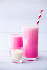 pink milk drink in tall glasses  isolated on white wooden table background, Selective focus, Healthy food for breakfast and snack..