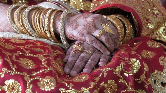 top view of indian bride hand with jewelry 