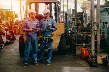 happy worker, working in heavy industry talking smiling together.