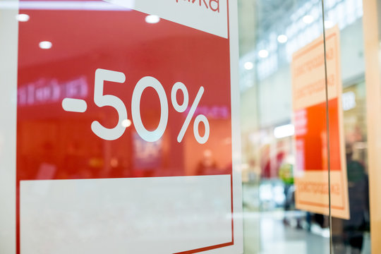 Retail Image Of A Sale Sign In A Clothing Store Window.shopping sale background.red Sale signs in shop window, big reductions. Marketing and advertising