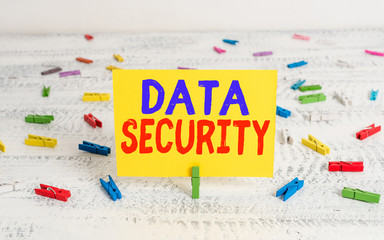Conceptual hand writing showing Data Security. Concept meaning the process of protecting data from unauthorized access Green clothepin white wood background reminder office supply
