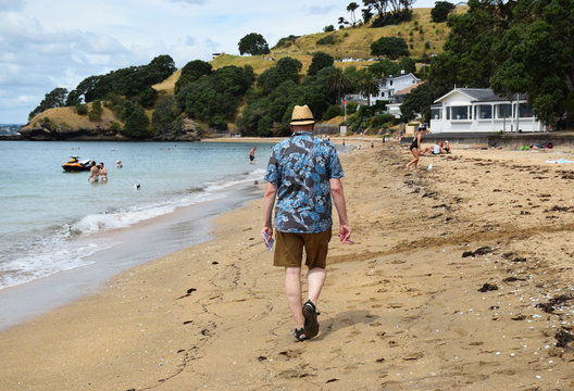 Old Man Walking Away Down The Beach